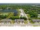 Aerial view of townhomes, lakes, and green spaces, highlighting the community's layout and surrounding environment at 1615 Primo Ct, Holly Hill, FL 32117