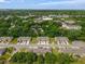 Aerial view showcasing neatly arranged townhomes with well-maintained lawns, trees, and landscaping in a residential area at 1615 Primo Ct, Holly Hill, FL 32117