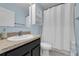 Bathroom featuring a vanity with storage and a shower-tub combo with curtain at 1615 Primo Ct, Holly Hill, FL 32117