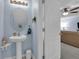 Charming half-bathroom with a pedestal sink and a decorative mirror at 1615 Primo Ct, Holly Hill, FL 32117