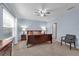 Cozy bedroom featuring carpet, a ceiling fan, natural light, and an ensuite bathroom at 1615 Primo Ct, Holly Hill, FL 32117