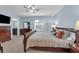 Well-lit bedroom with carpet, ceiling fan, and a large window providing natural light at 1615 Primo Ct, Holly Hill, FL 32117