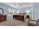 Serene bedroom with a comfortable bed, warm lighting, and ample natural light at 1615 Primo Ct, Holly Hill, FL 32117