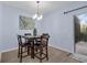 Cozy dining area with stylish lighting, seating for four, and access to the outdoor space at 1615 Primo Ct, Holly Hill, FL 32117