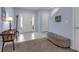 Inviting entryway with neutral tile flooring, a bench, and a coat rack creating a warm and welcoming first impression at 1615 Primo Ct, Holly Hill, FL 32117