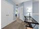 Upstairs hallway featuring a built-in desk and two bedrooms at the end of the hall at 1615 Primo Ct, Holly Hill, FL 32117