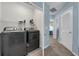 Well-equipped laundry area with modern washer and dryer units, and shelving at 1615 Primo Ct, Holly Hill, FL 32117