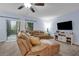 Inviting living room with a sectional sofa and sliding glass doors leading to the outdoor space at 1615 Primo Ct, Holly Hill, FL 32117