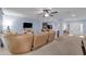 Open-concept living room featuring a kitchen bar, ceiling fan, and view of the front entry at 1615 Primo Ct, Holly Hill, FL 32117