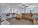 Open-concept living room featuring modern furniture, a breakfast bar, and stylish decor for a comfortable and chic living space at 1615 Primo Ct, Holly Hill, FL 32117