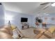 Bright living room with a kitchen bar and modern furnishings, including a flat-screen TV at 1615 Primo Ct, Holly Hill, FL 32117