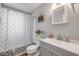 Clean and modern bathroom with gray vanity and shower with patterned curtain at 167 N Hill Ave # 60, Deland, FL 32724