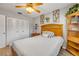 Comfortable bedroom featuring a wooden headboard, white comforter, and built-in shelves at 167 N Hill Ave # 60, Deland, FL 32724