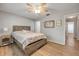 Bedroom with wood-look floors, neutral walls, and doorway to en-suite bathroom at 167 N Hill Ave # 60, Deland, FL 32724