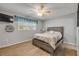Cozy bedroom with a ceiling fan, light gray walls, and wood-look floors at 167 N Hill Ave # 60, Deland, FL 32724