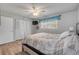 Comfortable bedroom with a large window with blue valance and double door closet at 167 N Hill Ave # 60, Deland, FL 32724