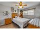 Cozy bedroom with light gray walls, wood furnishings, and a ceiling fan at 167 N Hill Ave # 60, Deland, FL 32724