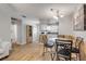 Cozy dining area with wood floors, bar seating, and an open layout to the kitchen at 167 N Hill Ave # 60, Deland, FL 32724