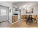 Open dining area with modern light fixture, wood-look floors, and easy kitchen access at 167 N Hill Ave # 60, Deland, FL 32724