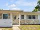 Charming single-story home featuring a stone accent wall and a welcoming front porch entrance at 167 N Hill Ave # 60, Deland, FL 32724