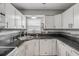 Bright kitchen featuring granite countertops, white cabinets, and stainless steel appliances at 167 N Hill Ave # 60, Deland, FL 32724