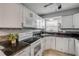 Well-lit kitchen features white cabinets, granite countertops, and stainless steel appliances at 167 N Hill Ave # 60, Deland, FL 32724