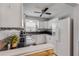 Bright kitchen features white cabinets, granite countertops, and stainless steel appliances at 167 N Hill Ave # 60, Deland, FL 32724