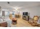 Bright living space with wood floors, open layout, and easy access to the dining and kitchen areas at 167 N Hill Ave # 60, Deland, FL 32724
