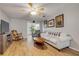 Inviting living room with wood floors, ceiling fan, and comfortable seating at 167 N Hill Ave # 60, Deland, FL 32724