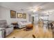 Comfortable living room with wood floors, sofa, and an open layout to dining area at 167 N Hill Ave # 60, Deland, FL 32724