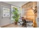Bright and airy office space with wood accent wall and a large plant by the windows at 167 N Hill Ave # 60, Deland, FL 32724