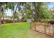 Well-maintained backyard with a wooden deck, privacy fence, and ample space for outdoor activities and relaxation at 1723 Needle Palm Dr, Edgewater, FL 32132
