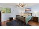 Cozy bedroom boasts natural lighting, wood floors, and calming decor at 1723 Needle Palm Dr, Edgewater, FL 32132