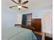 This bedroom includes a ceiling fan, wood floors, ensuite bathroom, and closet at 1723 Needle Palm Dr, Edgewater, FL 32132