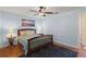 Bright bedroom with wood flooring, large rug, and bedside tables at 1723 Needle Palm Dr, Edgewater, FL 32132