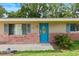 Inviting front entrance with a bright blue door and brick exterior at 1723 Needle Palm Dr, Edgewater, FL 32132