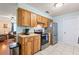 Functional kitchen with wooden cabinetry and modern appliances at 1723 Needle Palm Dr, Edgewater, FL 32132