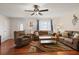 Cozy living room featuring hardwood floors, a ceiling fan, and comfortable seating at 1723 Needle Palm Dr, Edgewater, FL 32132