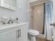 Bathroom featuring single sink vanity and shower with blue-patterned curtain and built-in corner shelves at 1920 Travelers Palm Dr, Edgewater, FL 32141
