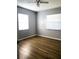 This bedroom has a ceiling fan, two windows, and wood flooring at 1920 Travelers Palm Dr, Edgewater, FL 32141