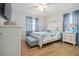 Cozy bedroom with white furniture, wood floors, a ceiling fan, and blue accents for a tranquil atmosphere at 1920 Travelers Palm Dr, Edgewater, FL 32141