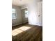 Bedroom features wood flooring, a mirrored closet, and a window at 1920 Travelers Palm Dr, Edgewater, FL 32141