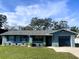 Attractive single-Gathering home with a lush green lawn, neat landscaping, and an attached single car garage at 1920 Travelers Palm Dr, Edgewater, FL 32141