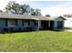 Cozy single-story home featuring shutters, freshly landscaped beds, healthy lawn, and an attached single-car garage at 1920 Travelers Palm Dr, Edgewater, FL 32141