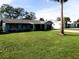 Quaint one-story home with a well-kept lawn and landscaping, adjacent to other houses in a quiet neighborhood at 1920 Travelers Palm Dr, Edgewater, FL 32141