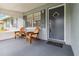 Inviting front porch featuring wood chairs and a small table, perfect for enjoying the outdoors at 1920 Travelers Palm Dr, Edgewater, FL 32141
