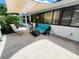 Comfortable patio with a cushioned sofa, side table and beautiful plants provides a relaxing atmosphere at 1941 Spruce Creek Lndg, Port Orange, FL 32128