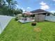 Private backyard with a wooden deck and an outdoor dining area, perfect for entertaining and enjoying the outdoors at 1941 Spruce Creek Lndg, Port Orange, FL 32128