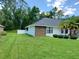 Well-maintained backyard with lush green grass and a privacy fence, creating a peaceful outdoor retreat at 1941 Spruce Creek Lndg, Port Orange, FL 32128