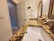 Bright bathroom featuring a granite countertop, white cabinets, and modern fixtures at 1941 Spruce Creek Lndg, Port Orange, FL 32128